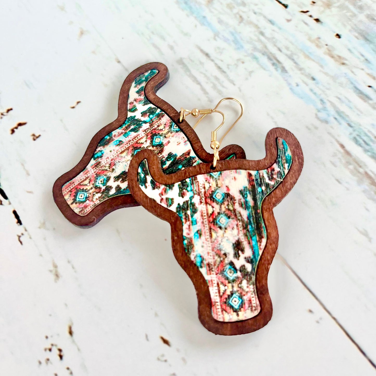 "Wooden cow head earrings with bold Aztec print design and minimalist version, perfect for boho and rustic style lovers."