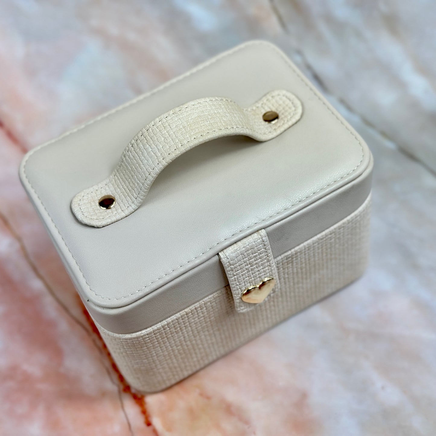 Elegant jewelry boxes in pink, cream, and large designs with compartments, mirrors, and gold heart accents, perfect for storing rings and jewelry."