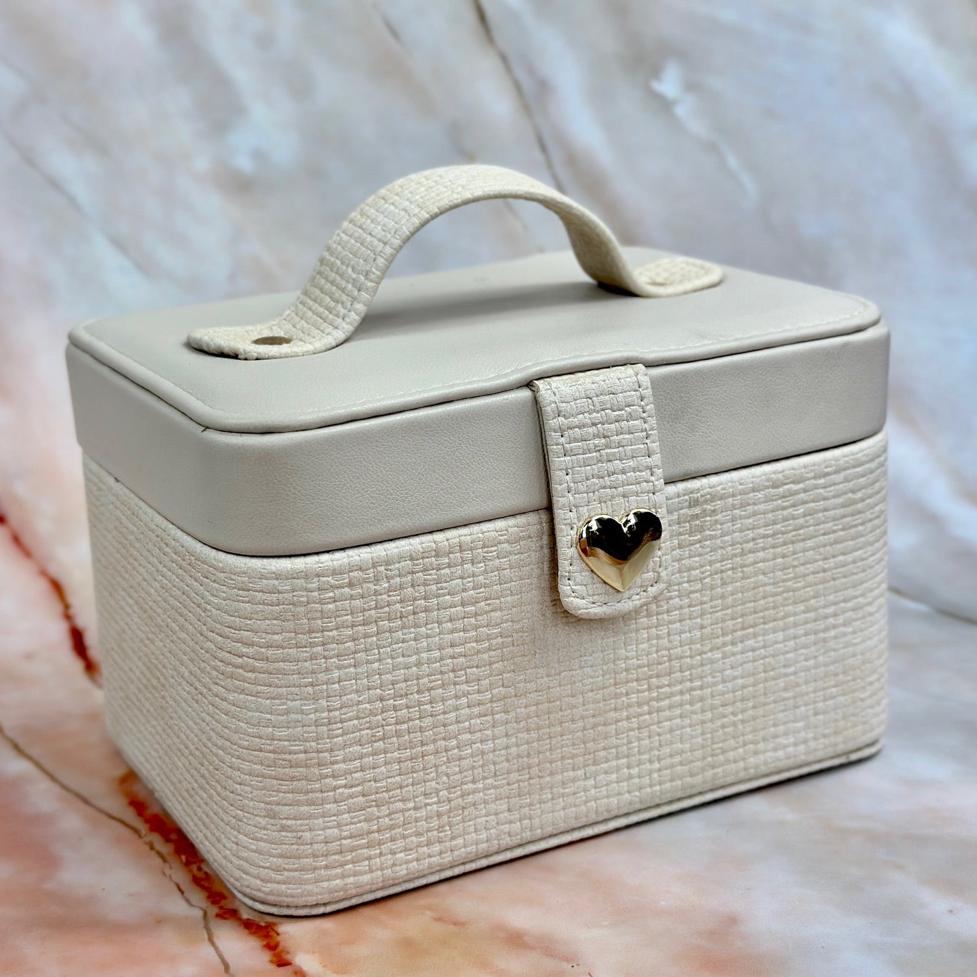 Elegant jewelry boxes in pink, cream, and large designs with compartments, mirrors, and gold heart accents, perfect for storing rings and jewelry."
