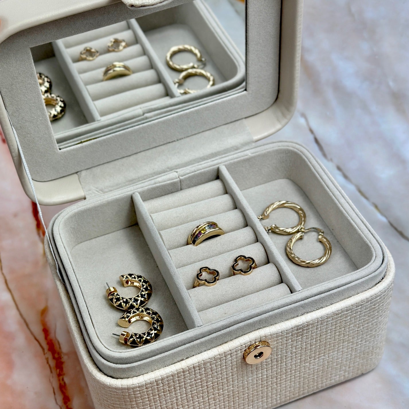 Elegant jewelry boxes in pink, cream, and large designs with compartments, mirrors, and gold heart accents, perfect for storing rings and jewelry."