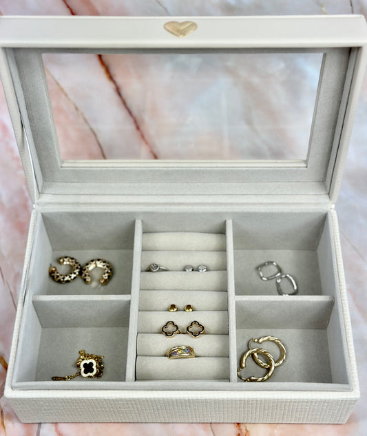 Elegant jewelry boxes in pink, cream, and large designs with compartments, mirrors, and gold heart accents, perfect for storing rings and jewelry."