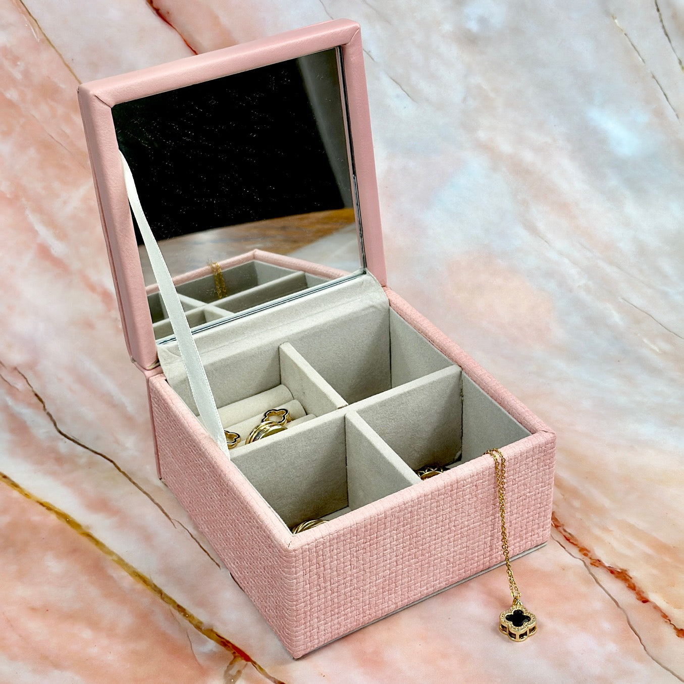 Elegant jewelry boxes in pink, cream, and large designs with compartments, mirrors, and gold heart accents, perfect for storing rings and jewelry."